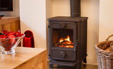 Freestanding wood-burning stove with a visible flame